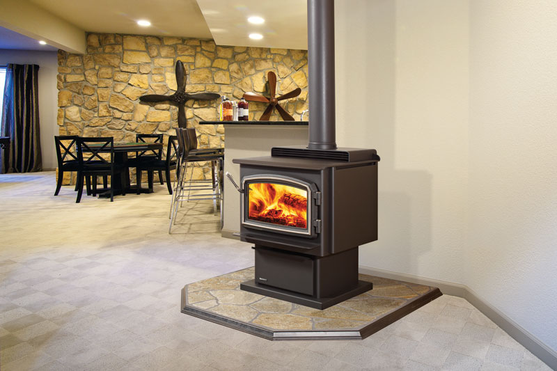 Black nickel trim free-standing wood stoves with table chairs and bar in the background.