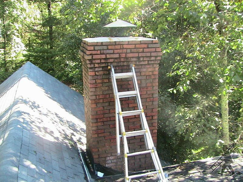 ladder laying up against brick chimney