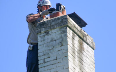 Tech inspecting chimney standing in Wescosville PA, and Exton PA