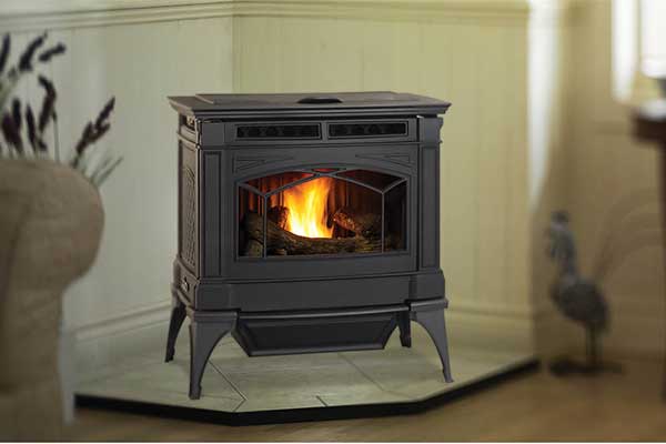 Hampton GC60 corner stove in den with chairs on both sides and windows looking over a barn.