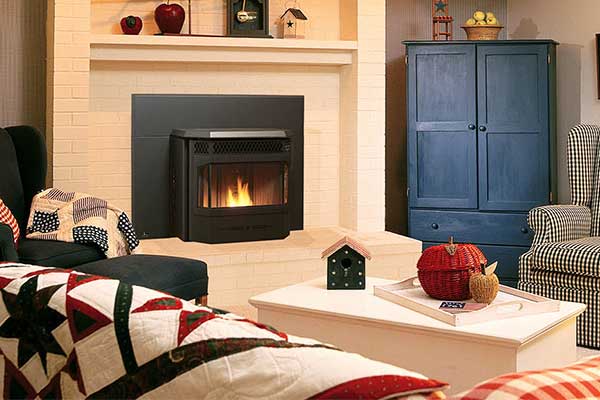 Heat your home with energy efficient stove or insert. Surround is white brick as well as hearth. To the right there is a colonial blue wardrobe.