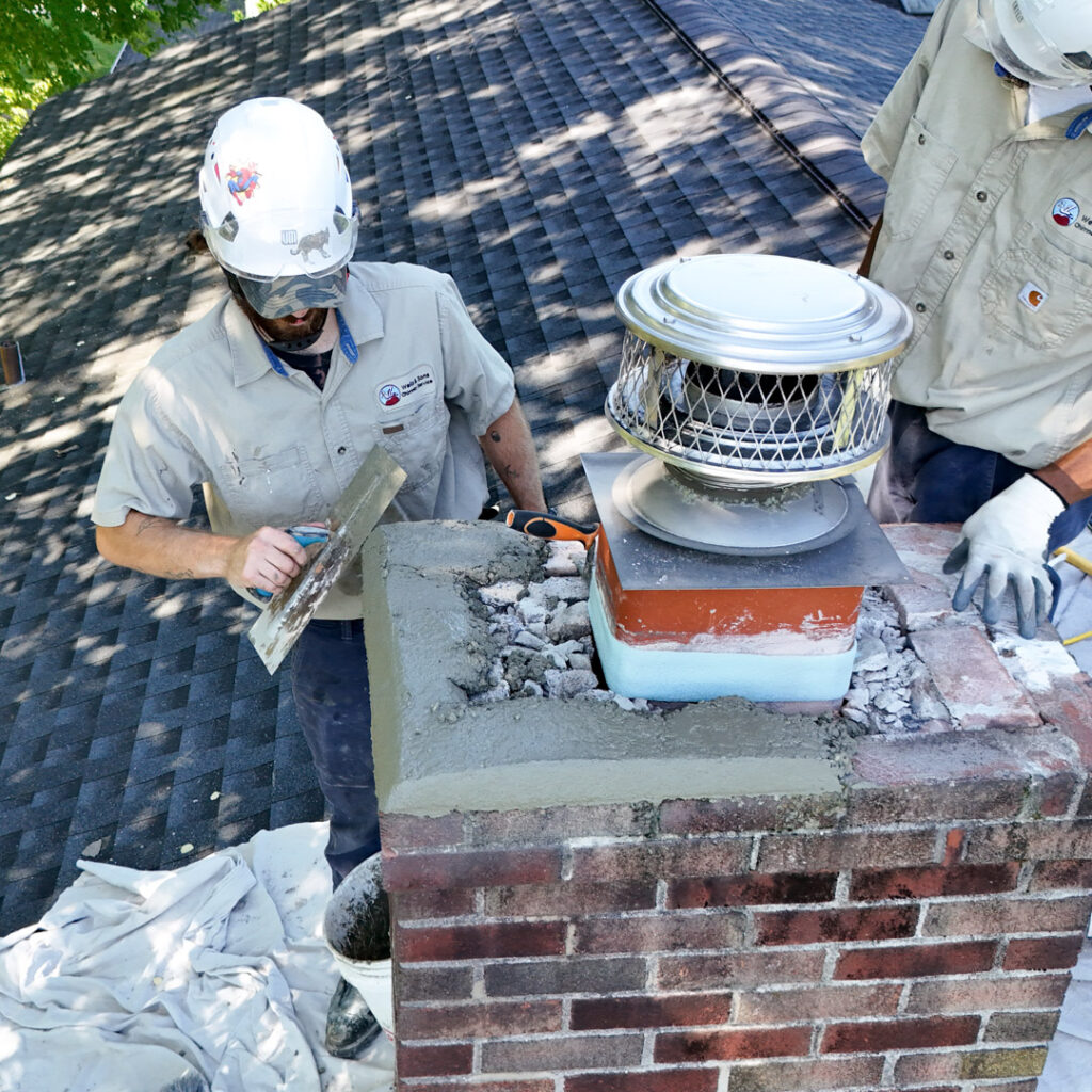 Cracked chimney crown being fixed in Chester, PA.